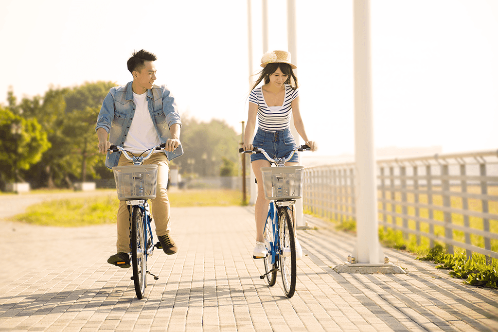 two people riding bikes together