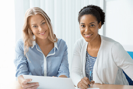 two women smiling at you