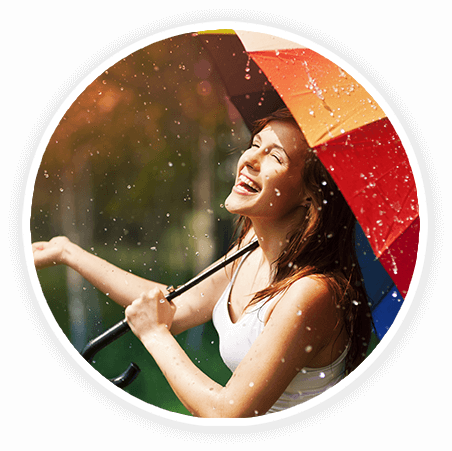 moman laughing under an umbrella in the rain