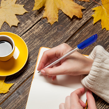 person writing in journal